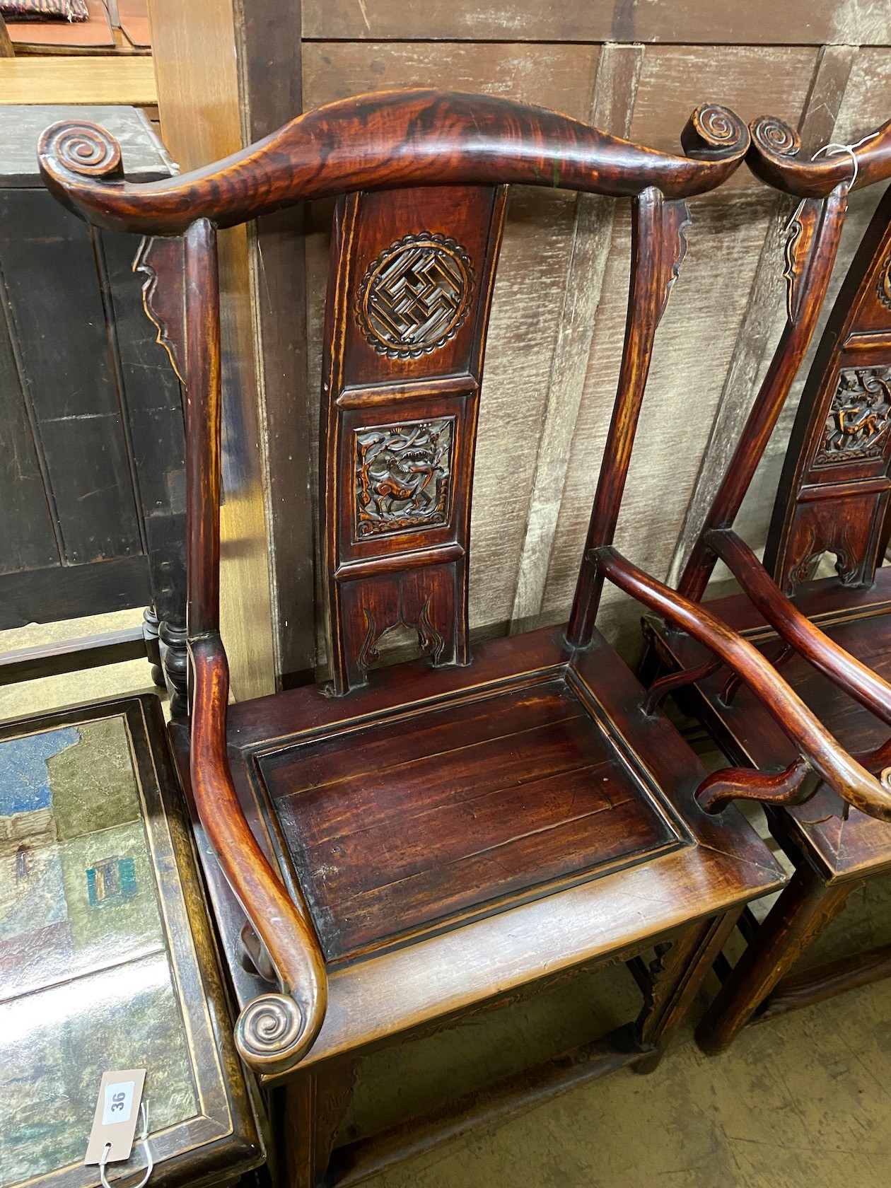 A pair of Chinese elm elbow chairs, width 63cm, depth 50cm, height 118cm